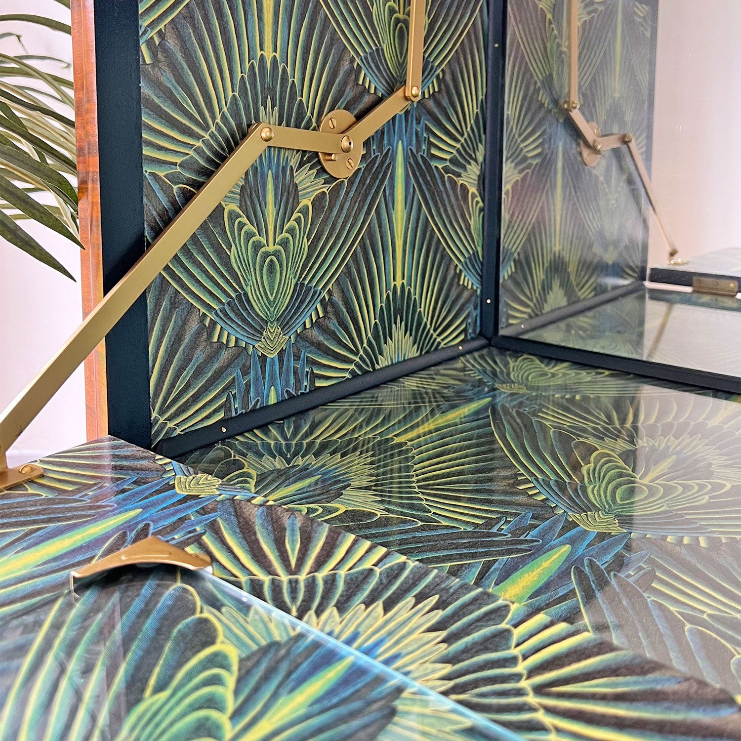 Interior featuring Divine Savages 'Gershwing' wallpaper – Opulent green and blue feathered Art Deco print decoupaged inside with glass protector.