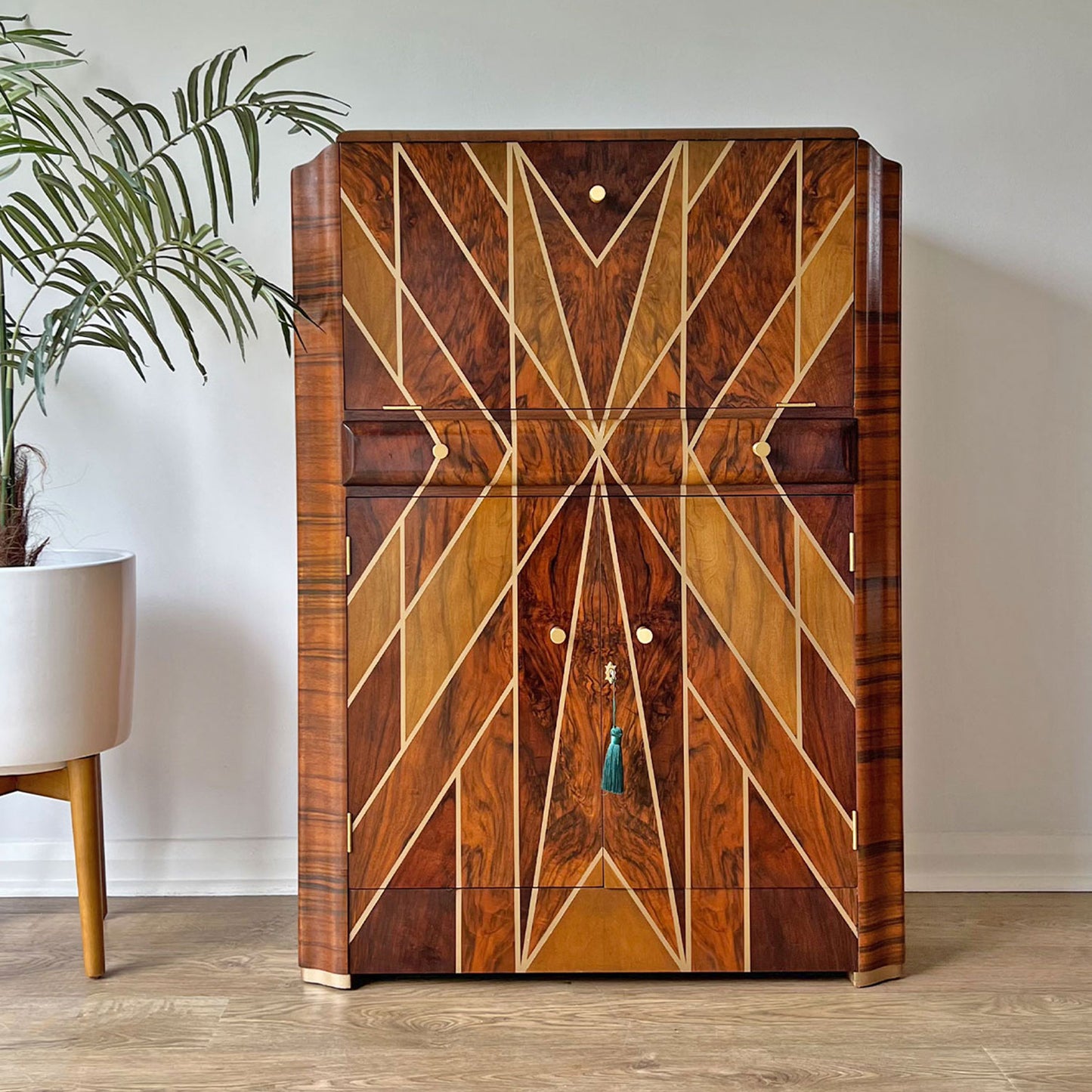 Front view of Art Deco drinks cabinet – A luxury walnut cocktail cabinet with a bespoke gold geometric design, solid brass handles, and a high-gloss finish.